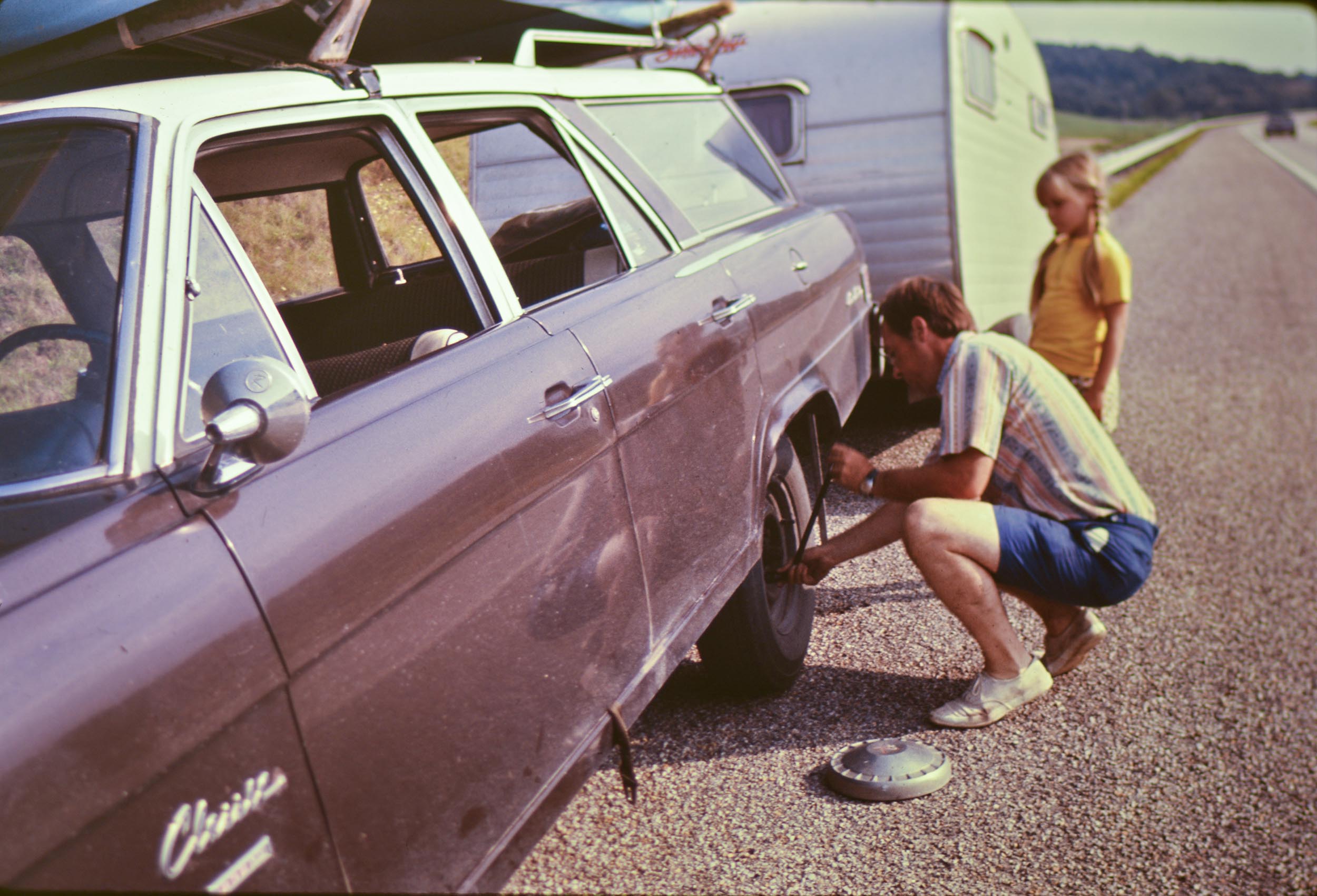 The family was traveling on the interstate to Myrtle Beach in 1973 and the tire came apart on the good old '65 Rambler Classic Wagon. Luckily my dad had the spare ready to go. View full size.
