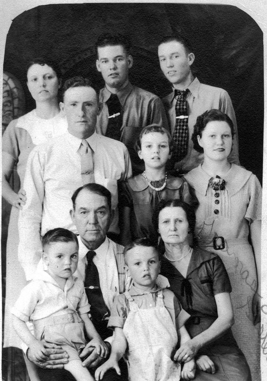 Grandmother's Family Portrait. In the middle row: Lloyd Nichols, Lillian (Nichols) Newcomer, & Myrtle Nichols.  Probably taken in the early 30's in West Texas. View full size.