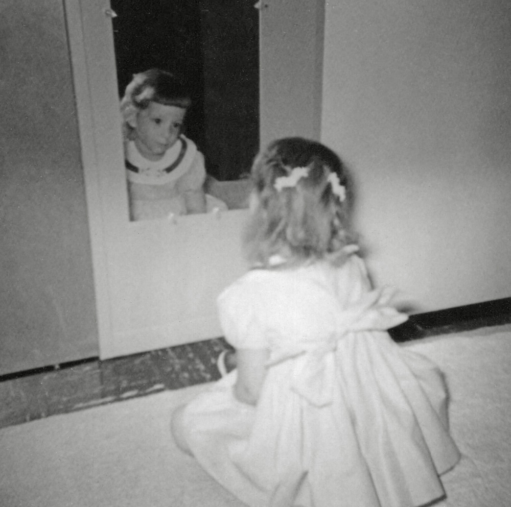 Not sure why I was sitting in front of the mirror in my mother’s bedroom on this occasion. Guess it was just something for a little girl to do that day.