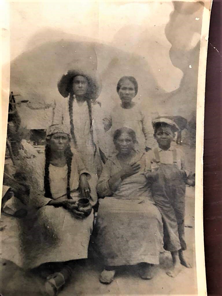 Hi! 
My family is from Coahuila in North Mexico (about 70 miles from Eagle Pass Tx. border) and my father recently found this old and only picture of my grandpa as a kid. He was born in 1920, so this must be from around 1925-27). The woman on the left (of my grandfather) is my great grandmother (I don't know date or place of birht). 
Is there anything on the picture that indicates if it is a native american group? 
