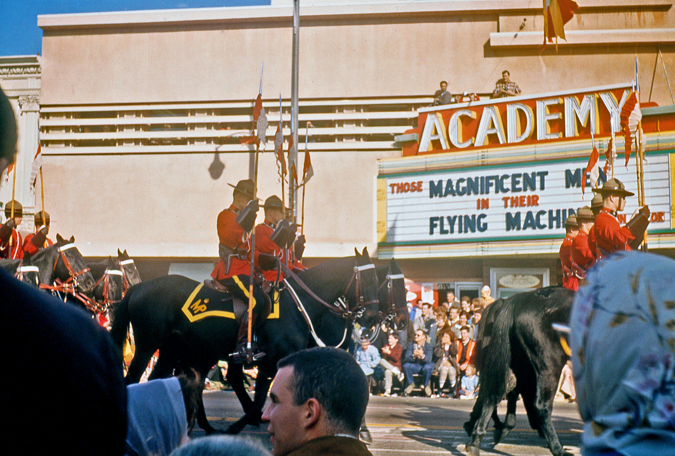 Pasadena's Academy Theatre, backdrop to the Rose Parade of January 1966. Found 35mm Ektachrome slide. View full size.