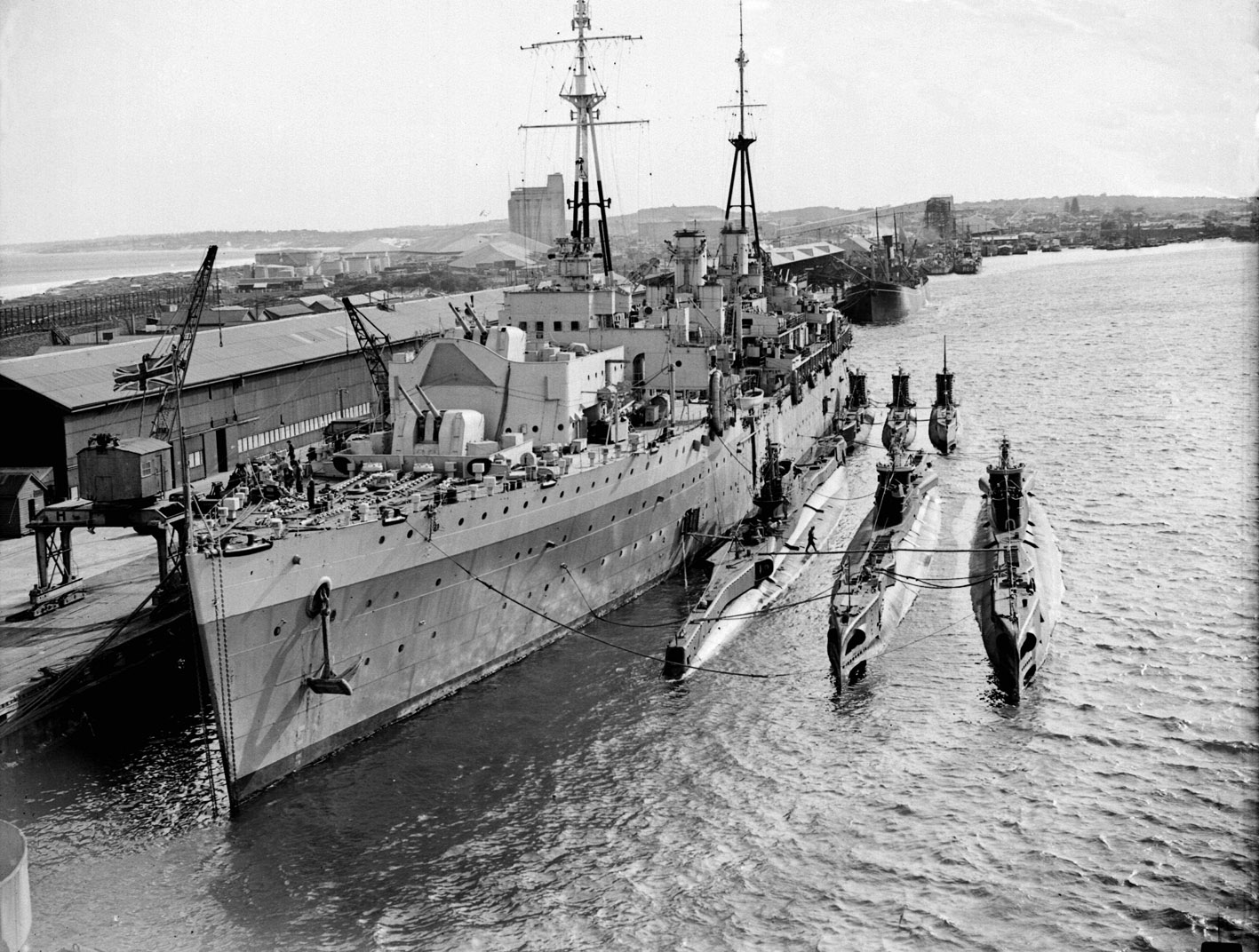HMS Adamant and British submarines in Fremantle Harbour in Western Australia, 1946. View full size.