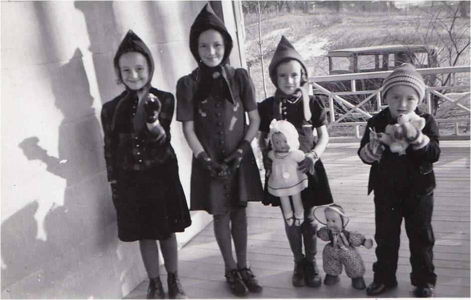 Christmas day, 1940.  These are my four little cousins - Lenore, Isabel, Anne and Murray - all older than I, because I didn't appear for another dozen years.  They are paying a call on their grandmother and aunts, from the farm next door.  Their father's car was a Whippet, but I don't know what year.  I still live in this house, and it has much the same view, although the suburbs are encroaching.  Photo taken by their, and my, aunt Jean. View full size.