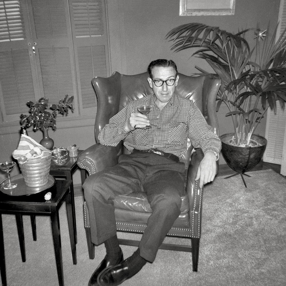 Connoisseur, bon vivant, raconteur, collector of first editions, advertising executive, typography historian, WWII Army Air Corps Photo Recon NCO, and my mother's twin brother, Uncle Albert hoists a Christmas toast in the living room of his San Francisco home in December 1960. You can tell it's Christmas by the holly in the table vase and the star ornament sticking up from the areca on the right; that's his Christmas tree. I took this with my Brownie Starmite. Full size.