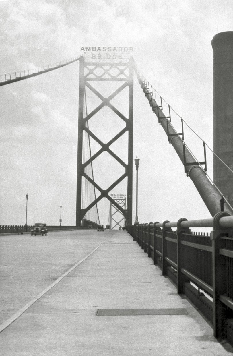 Early picture of the Ambassador Bridge that links Detroit Michigan and Windsor Ontario. Bridge was built in 1929 and this looks like it was taken not too much longer after that. Note on the right side the sidewalk and people walking on it, this was closed a long time ago as it was not part of the bridge's charter (at least what I have read). From my negatives collection. View full size.
