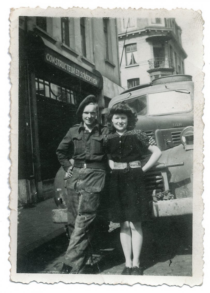 "That’s me and my girlfriend, Estelle Dillon. And that was in Berchem, Antwerp, not long after it was liberated in September 1944."
"During the occupation, she must have been 13 or 14, because she was 16 when I knew her. But, anyway, she was quite young. She used to go out on her bike into the country, and she used to get food and smuggle it back into Antwerp. Now if the Germans had caught her they wouldn't have liked it, putting it mildly! But she said 'I never got caught!'"
-- Uncle Walter Quiney, a teenage tipper truck driver in the R.A.S.C, who had his 19th birthday on the beaches of Normandy a few months before this photo in front of his truck was taken. It's a Canadian Dodge he picked up new from Liverpool Docks earlier in the year, landed in Normandy on D+16, (The storm a week before meant they went back to using landing craft rather than the storm damaged quay) helped clean up Caen and Antwerp, before finally ending up in Berlin a year later, pretty much clapped out!View full size.

