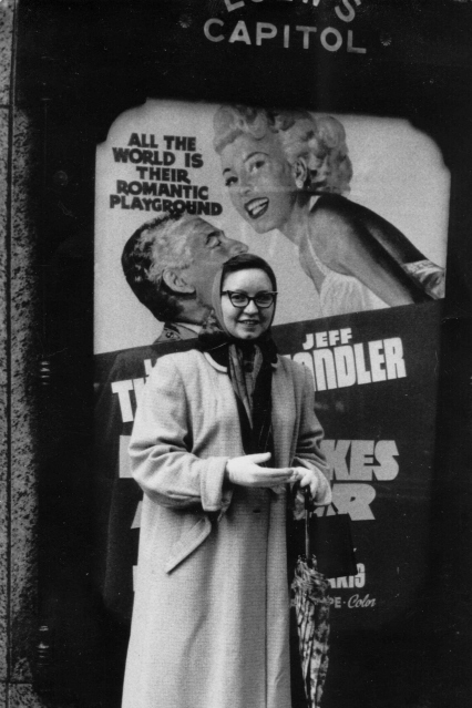 I've always liked this photo of my late Aunt Margaret. I found that the movie whose advertising poster she is standing in front of is promoting a movie titled "The Lady Takes a Flyer," starring Lana Turner and Jeff Chandler. It wasn't until a few minutes ago, though, that I noticed the "Loew's Capital" emblem above the poster. Since there's nothing you can't find out about on the internet, I've just learned that "The Lady Takes a Flyer" premiered at this now-demolished theatre (formerly located at 1328 F Street NW, Washington, DC) the week of February 26, 1958.  Must have been a rainy February, given Aunt Margaret's head scarf and umbrella!