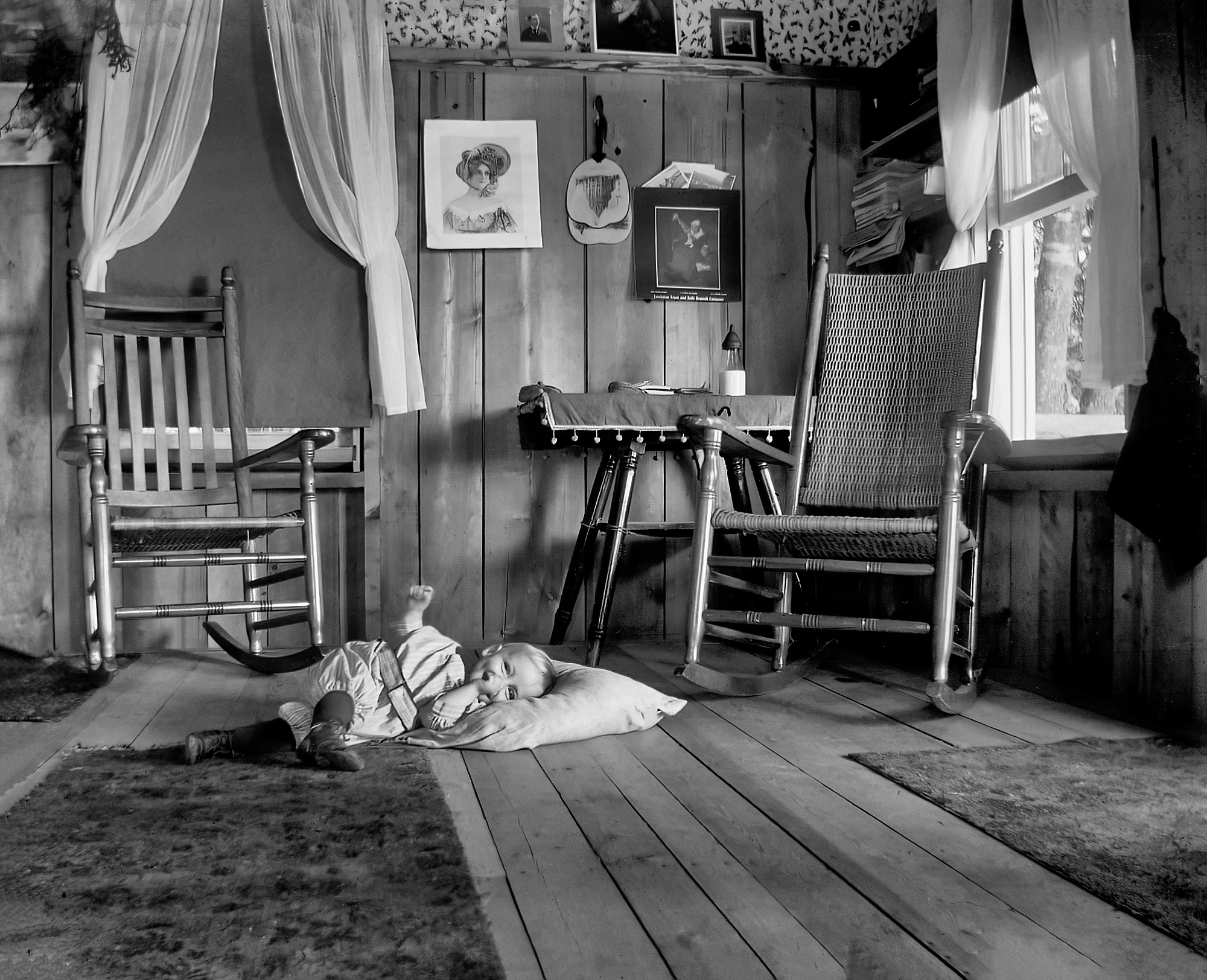 This image of a baby relaxing on the floor comes from a set of glass negatives taken in Pawnee City, Nebraska, around 1910 or earlier. View full size.