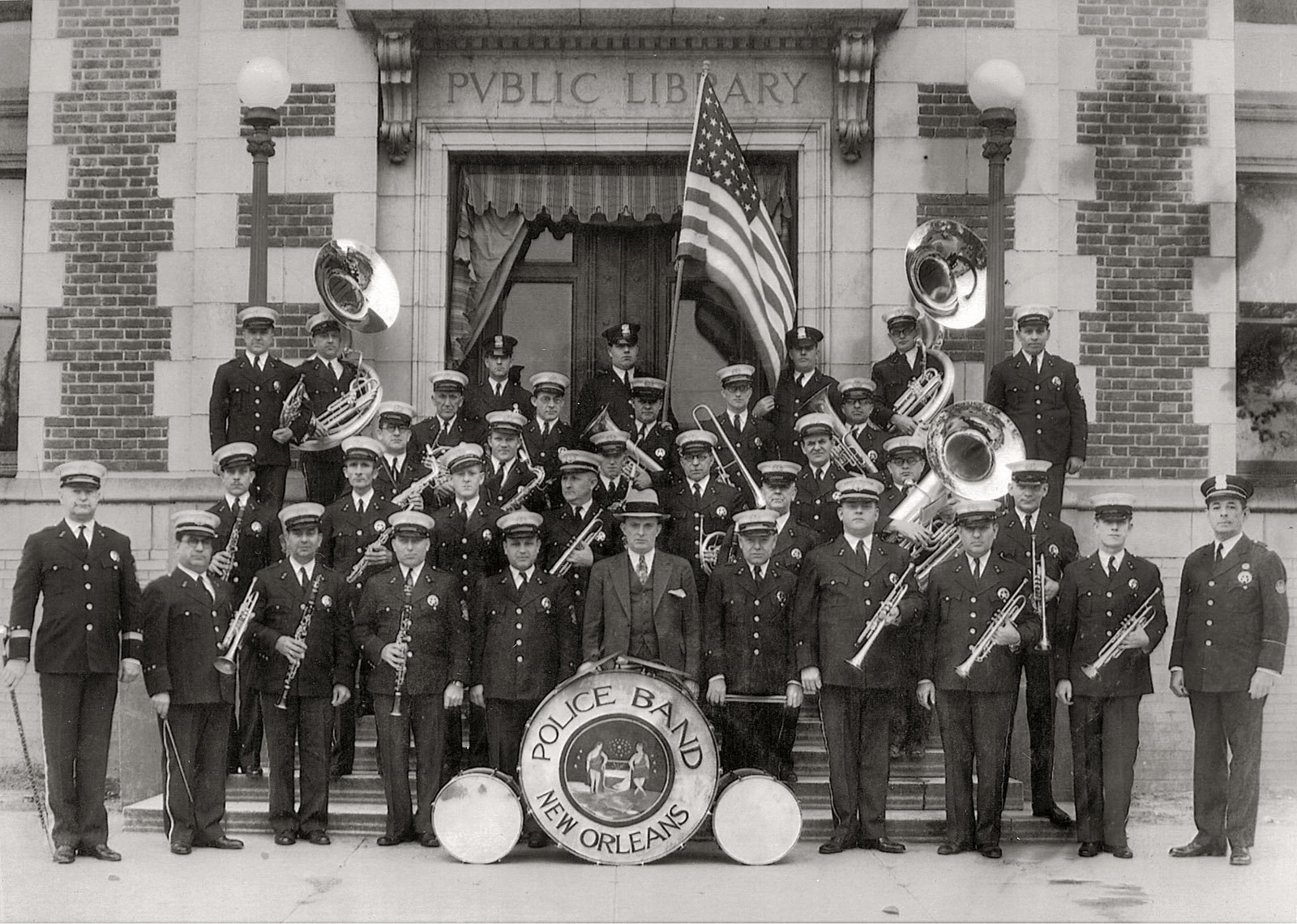 New Orleans Police Department Band in front of the Carnegie branch library building Uptown at Napoleon Avenue & Magazine Street, late 1920s. Photo courtesy of Mr. Eugene Nunez. His father, officer Alcide Nunez, is in the front row, third from left. Alcide Nunez recorded extensively during his time up in New York City with the band The Louisiana Five back in 1919. View full size.