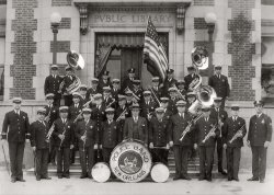 New Orleans Police Department Band in front of the Carnegie branch library building Uptown at Napoleon Avenue & Magazine Street, late 1920s. Photo courtesy of Mr. Eugene Nunez. His father, officer Alcide Nunez, is in the front row, third from left. Alcide Nunez recorded extensively during his time up in New York City with the band The Louisiana Five back in 1919. View full size.
