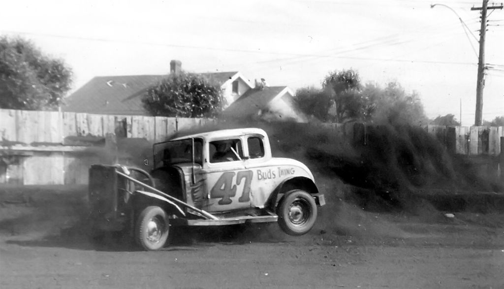 1954 Jalopy Racing in its glory days.  Many beautiful coupes and sedans were destroyed for the sake of racing.  I was 10 years old at the time and spent every Wednesday with my dad, friends or if you were lucky taken into the pits with a driver. This is Barry K, one of the top dogs at the Canadian Lakehead Exhibition grounds here in Fort William, Ontario, now Thunder Bay. The stands would be jammed with hundreds of fans cheering for their favourite drivers.  Most race tracks in those days were right in the center of town to the chagrin of many local residents.  A steel '32 Ford coupe body today in good condition could bring at least $10,000.  How I miss those wonderful times. View full size.