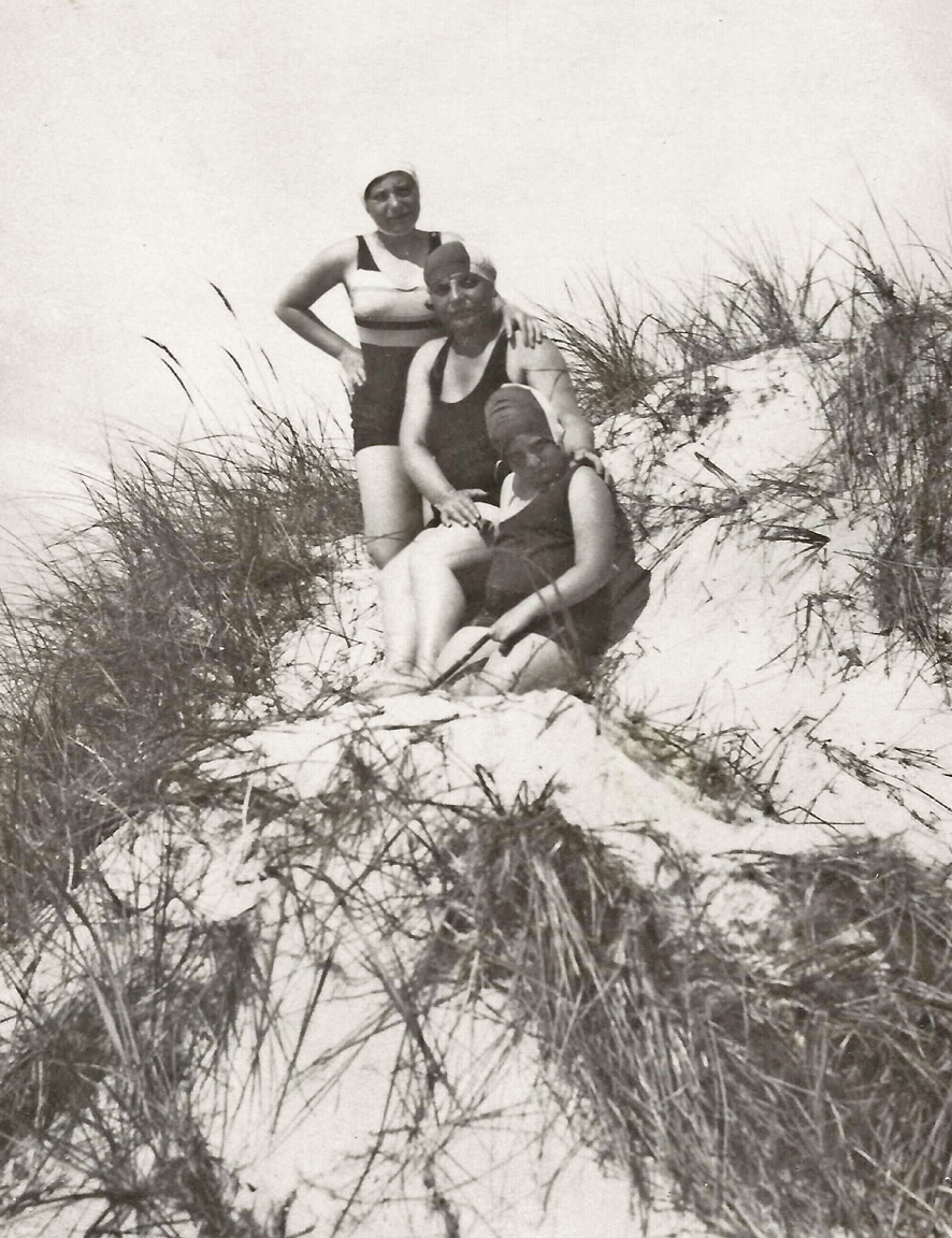 The same three women previously seen on the beach, gather on the dunes with rubber swim caps and bathing suits. The place is probably Lithuania. The date is some time in the 1920s. My best guess at who these people are, is my grandmother’s two older sisters and her mother (center). That would have made them my mother’s aunts and grandmother. Because they lived in Vilna (now named Vilnius) and my mother lived in Brooklyn, New York, she and these relatives never met.