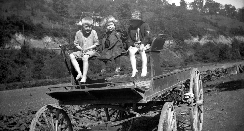This photo was taken in California Hollow, East Liverpool, Ohio in 1923. The Y&O Railroad right of way is on the hillside in the background. The girl is my Aunt Betty, the boys her cousins. View full size.