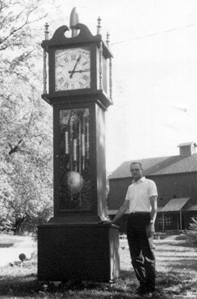 Found this pic with the rest of my Grandmother's things. I don't know the person standing by the clock. The photo is probably from the 1950's. My Grandparents way back collected, repaired and sold antique clocks.
