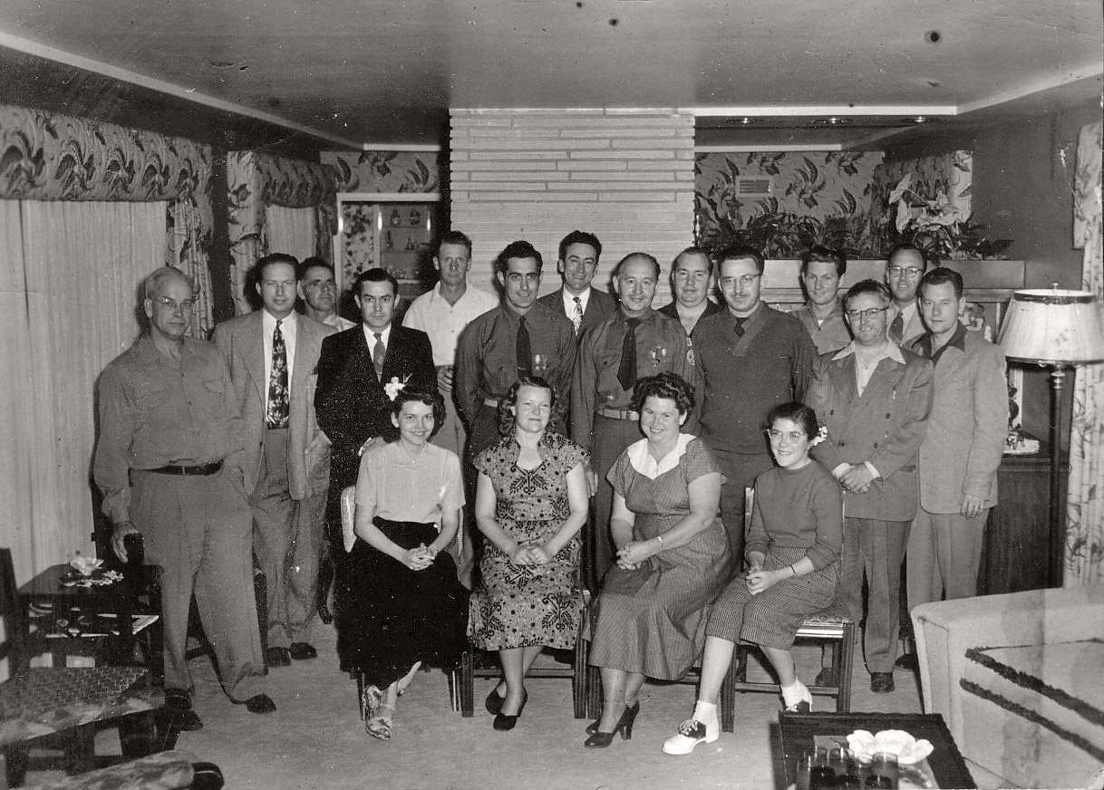 Taken mid 1940's, maybe a war's over party? My grandpa Frank on the far right next to the lamp, my grandma Grace 2nd from the left in the front row. View full size.