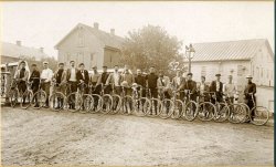 This photo of the Sidney Ohio Cycling club was taken in about 1895.  The man in the center is my great grandfather, Burt Heck who left the original to me.   At the height of its activities, the club had several dozen members. These guys would cycle 40 miles on a Sunday morning.  

Some interesting details are the date 1877 engraved on the roof peak of the house in the background and the kid on the far left trying to get into the picture.  Also there are 19 riders and 20 bikes which suggests the photographer was one of the group.

The original print is a very high resolution.  I have a poster size print on my wall and it looks fantastic. View full size.
