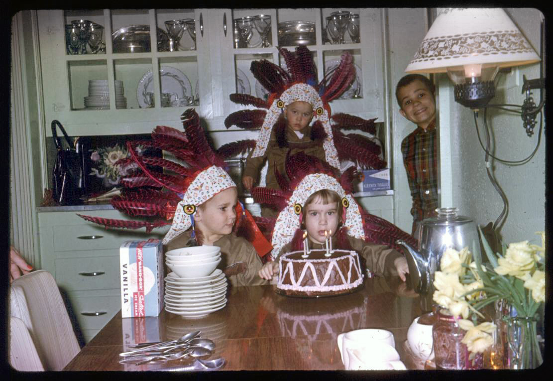 My nephews and I celebrating my Native American themed birthday.  It's spring of 1964 in North Carolina as noted by the jonquils on the table. Kodachrome slide taken with my father's Kodak Automatic 35 camera. View full size.