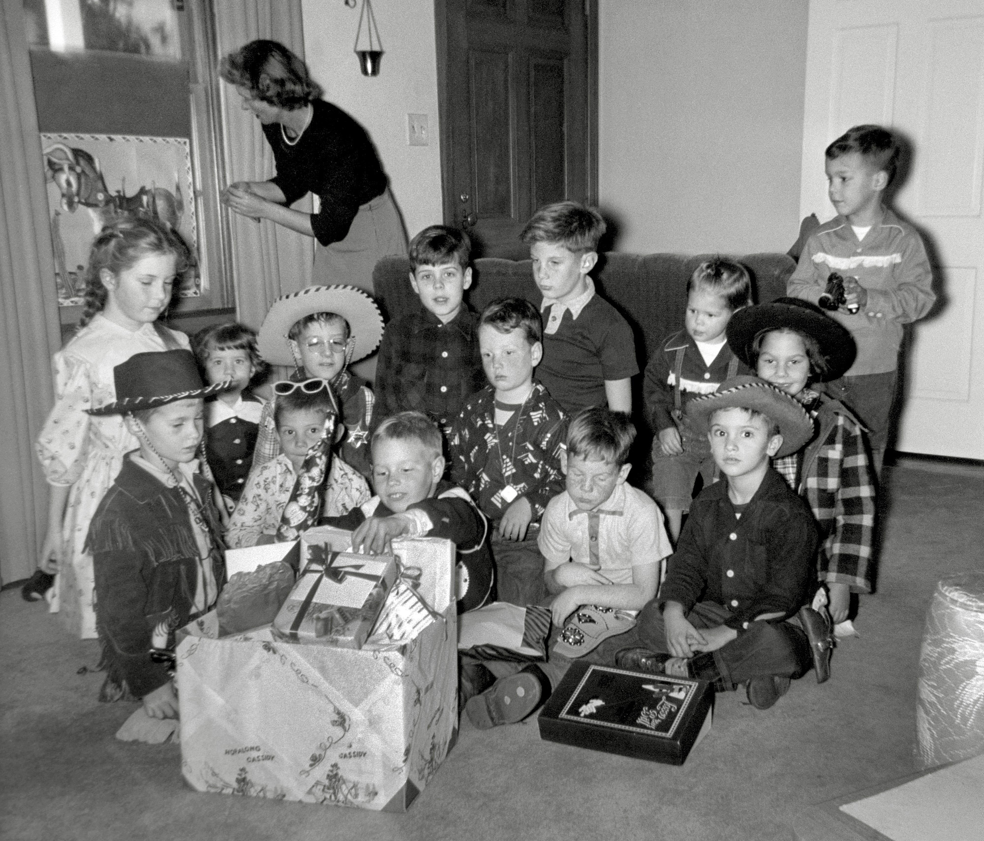 Larkspur, California, January 7, 1953. A photo of me I didn't know existed until a few days ago. I'm the second cowboy hat from the left at my best friend's 6th birthday party; I'd turned 6 the previous August. It's one of the rare childhood events that I've always carried a memory of; specifically: I insisted on leaving the party early so I could get home in time to watch "Time for Beany" on TV. My brother - whose hat that had been - came over and walked me home. My other classmates are the kid with the giant glasses on his head and the cowgirl behind the wide-eyed boy at right; I met up with her at our high school Class of '64 50th reunion last September. Others are mostly relatives, including June Cleaver his aunt setting up pin-the-tail-on-the-donkey. I gotta say, for a kid with a birthday so close to Christmas, it looks like my friend made out like a bandit.

Many thanks to his sister, the little girl at my side, for getting this negative to me to scan. View full size.