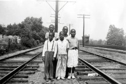 Somewhere between Hyattsville proper, and Riverdale Park just off U.S. # One. A happy looking bunch. Taken by my Uncle, Nolan Miller of Beltsville, Maryland. View full size.
JD TowerThis view is looking towards Baltimore. The tracks at far right is the B&amp;O Washington Branch. JD Tower in the background, controlled the junction here for the line down through Bladensburg to Sheppards Point and connections to Potomac Yard.
The boys are standing on the double track Capitol Traction line [note the poles with crossarms supporting trolley wire...] that came out Rhode Island Ave. and entered private right of way just south of here. This line originally ran to Laurel, Md., but was cut back to Branchville, and finally to Beltsville before it was removed in the late 50's/early 60's. Much of the right of way is still quite visible.
JD Tower looked very much like this until it was removed in the 1980's. This is still a very busy junction on what is now CSX, and is controlled from many miles from here.
(ShorpyBlog, Member Gallery)