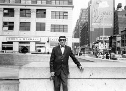 This is my grandfather, John J. Hennessy, also known as Black Jack.  He's photographed just to the side of the GPO in New York City, probably in the late 50's or early 60's, note the Horn and Hardart Automat just behind him. He was quite the dapper figure, and this photo was likely taken by his partner in crime Dinny Lambert.  They were both from Arklow in Co. Wicklow, Ireland, but had settled on the west side, what is now known as Chelsea, in Manhattan.  This photo has generated many stories about Grandpa, and his banjo hat, seen in the photo, not to mention his pretty fantastic dress sense.  We also have some amazing photos he took of his work on the subways he helped to build.  I'll dig them out next. View full size.
Smooth dudeGreat shot. My sister lives nearby. I will have to visit this spot and see how it looks next time I'm there. Thanks for sharing this.
(ShorpyBlog, Member Gallery)