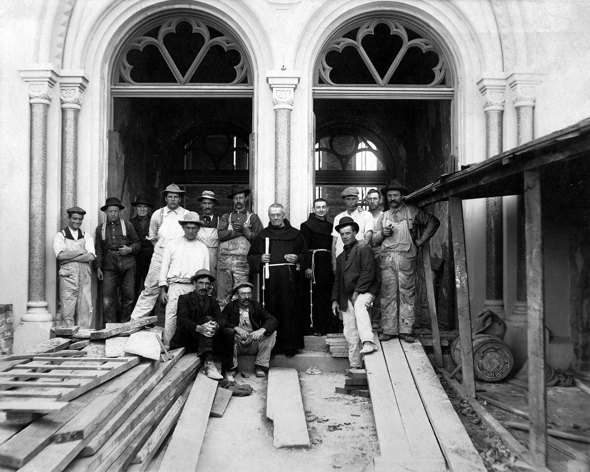San Francisco c. 1902. Building St. Boniface Church. The monk in the center, holding the roll of plans, is the German-born Adrian Wewer, O.S.F (1836-1914), architect of this and over 100 church and other buildings in the U.S. Next to him on the left, the big strapping guy in the dark hat and holding a cigar stub, is my grandfather on my mother's side. Four years later, the building was reduced to an empty shell in the earthquake and fire. Scanned from a period 8x10 probably contact-printed from a glass plate. View full size.