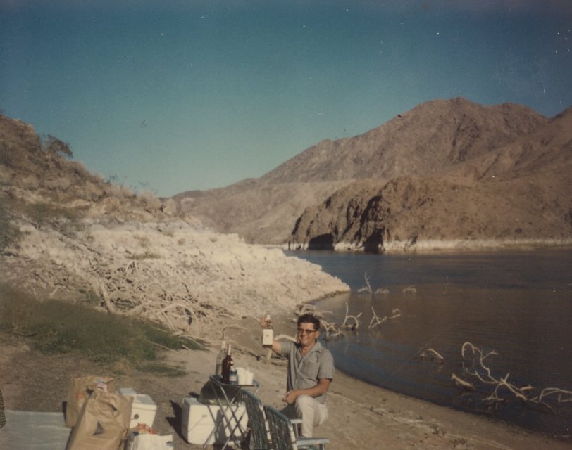 From a collection of mostly blurry pictures set I think set at Lake Mead, or up behind Davis Dam in Arizona with friends of my grandparents boating. At first seeing this picture I thought it was my dad, except he was a complete non-drinker, looks too young to be my grandpa by this time (late 1960's)so I'm assuming it's one of their friends. Anyway everyone knows booze and boating go hand in hand. View full size.
