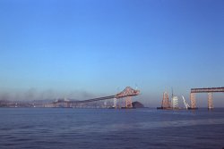 The Richmond-San Rafael bridge on San Francisco Bay under construction, November 30, 1955. Shot by my brother on 35mm Kodachrome from a car ferry heading east toward Richmond. Smoke at left is from a San Rafael-bound ferry passing out of camera range to the north. View full size.