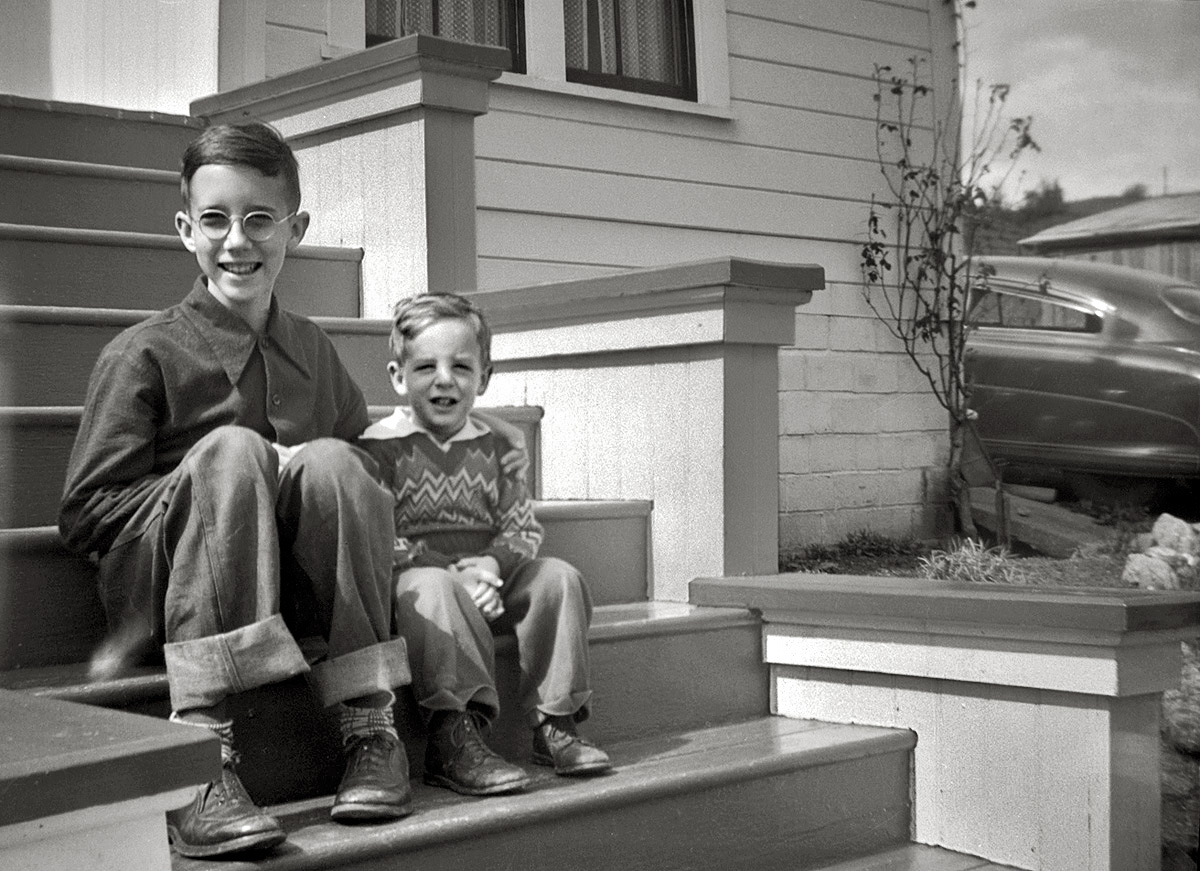 My brother and me, blissfully unaware of what our hair would be like 25 years later. On a 1949 visit to our grandparents in Calpella, Calif. On the right, there's the family Hudson when it was still new. From a 120 roll film negative shot by my sister. View full size.