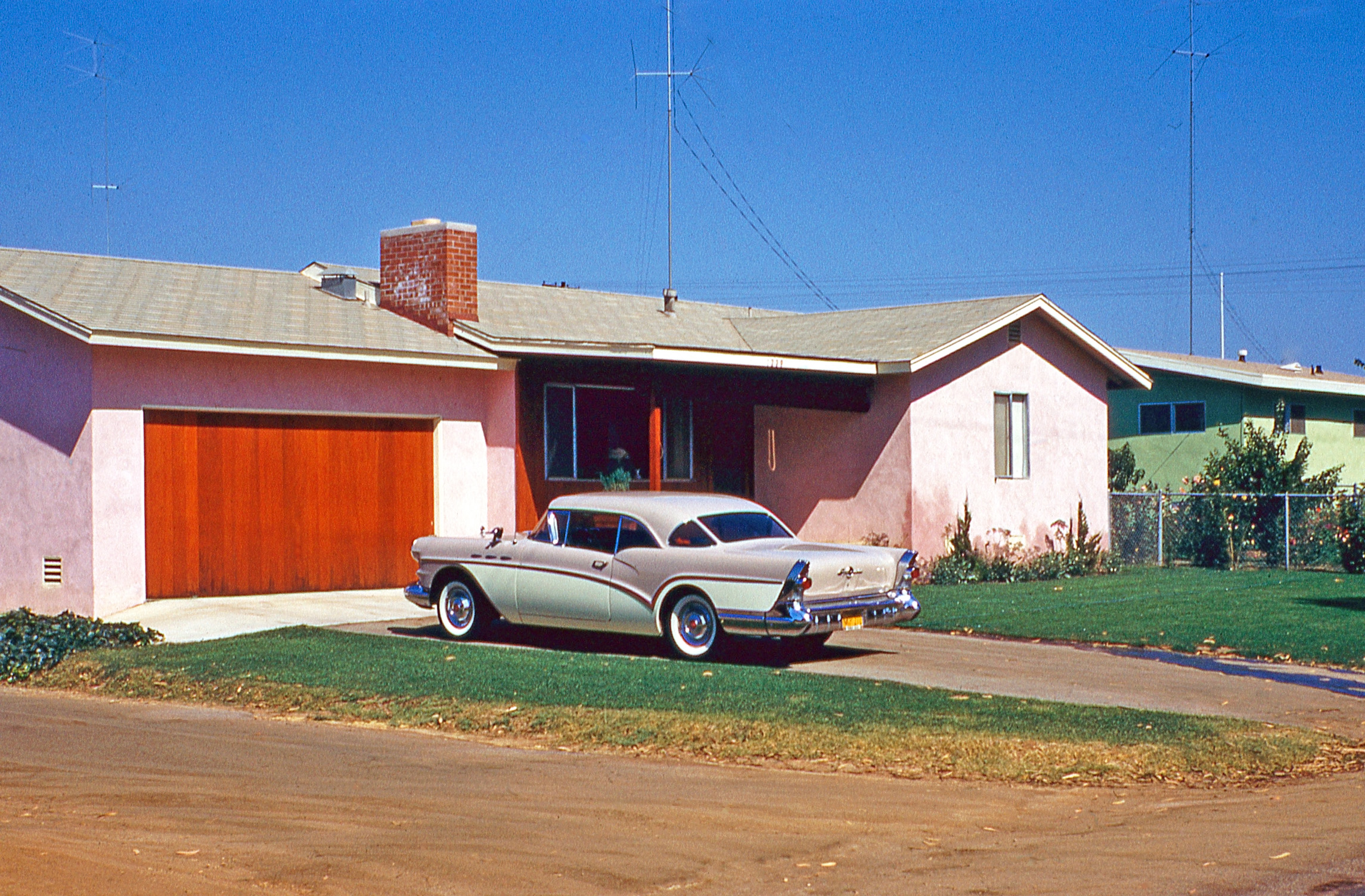 A 1957 Buick, houses in colors not seen anymore, and lots of antennas. A 35mm Kodachrome slide I found somewhere. View full size.