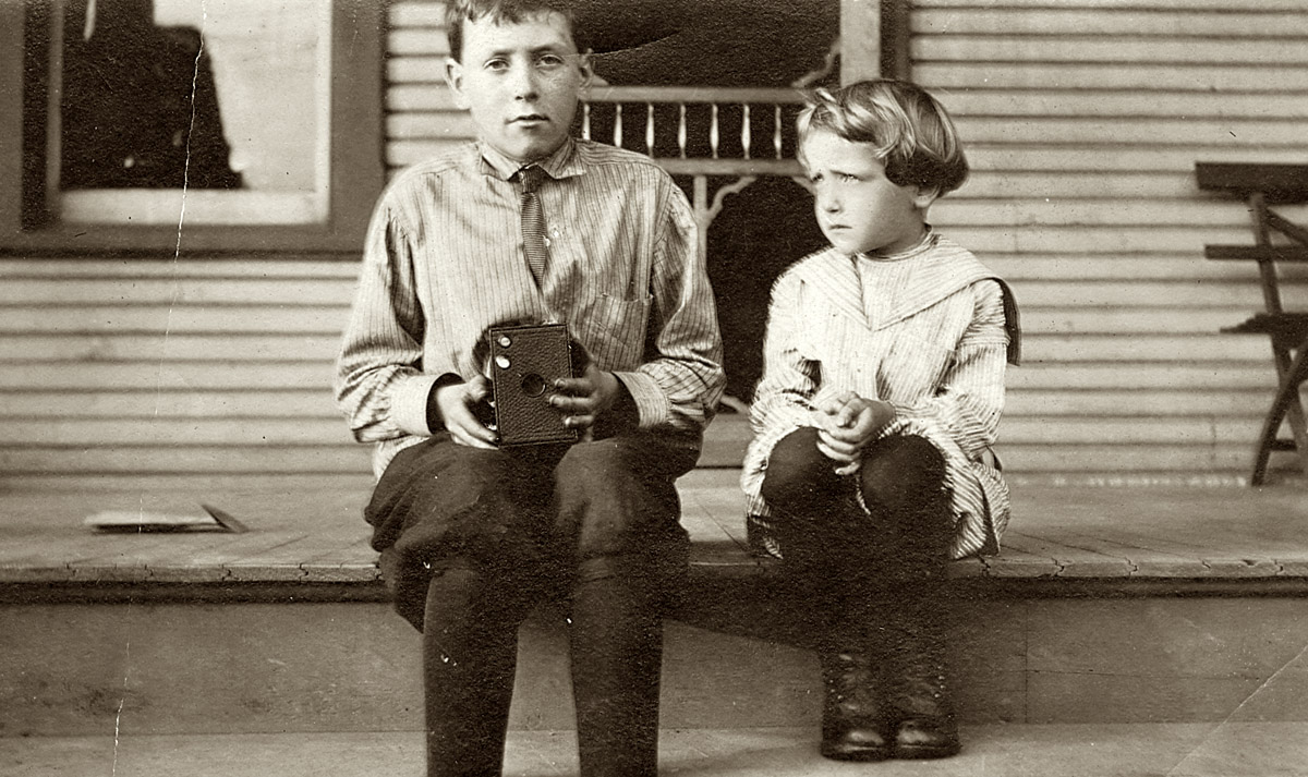 Proud young man showing off his Brownie camera circa 1910.