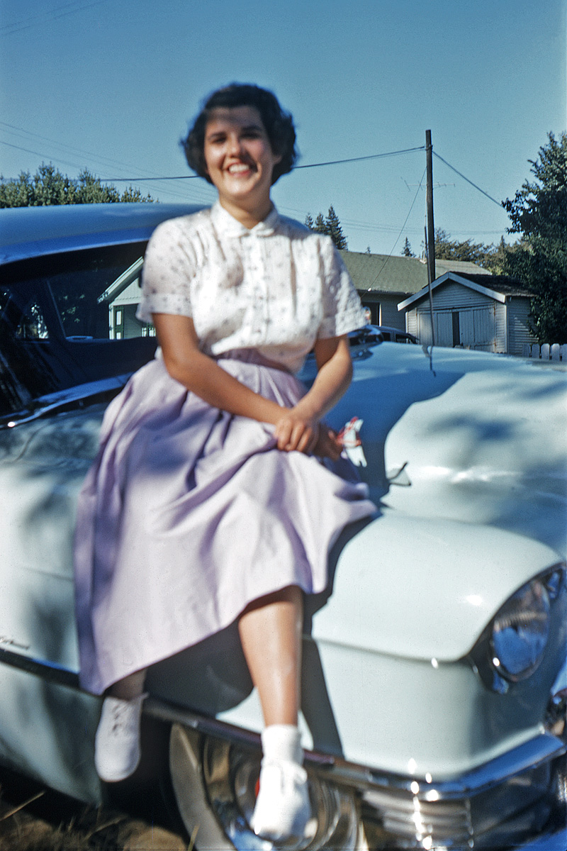 June 1956. My brother plants his girlfriend on  a convenient Cadillac (her father's, I think), doesn't focus, and shoots this Kodachrome.