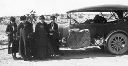 This was taken somewhere in the Great Plains, moving to the West Coast. My grandparents moved from New York state to California in 1920. My grandfather snapped the photo: My grandmother (far right) standing next to her mother. Grandmother's sister is at far left, next to my grandfather's mother. What a fun trip. View full size.
In the desertLooking in the background of the photo, you have Joshua trees, which reside in the deserts of California, Arizona, Nevada, etc. So it looks like they are closer to their destination here. Dressed like that I am hoping it's winter.
(ShorpyBlog, Member Gallery)