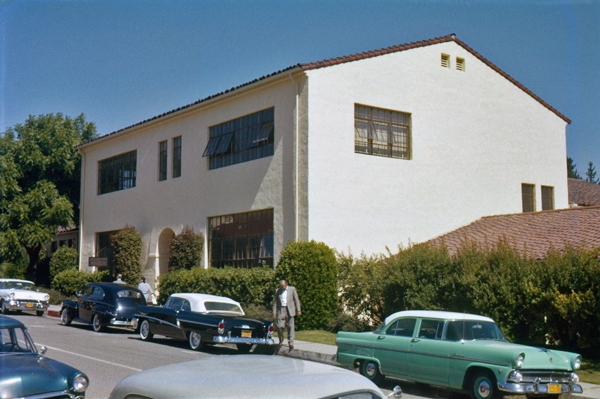 More classic cars in their natural habitat. The AC building at Cal Poly, San Luis Obispo campus, June 1957. Highlights: choice 1956 Mercury convertible; nice shine on the 1955 Ford Customline V8 two-tone. Somebody please identify the nicely-preserved black sedan in front of the Merc. Bonus: 1950s college professor in characteristic native garb. Ektachrome slide shot by my brother. View full size.