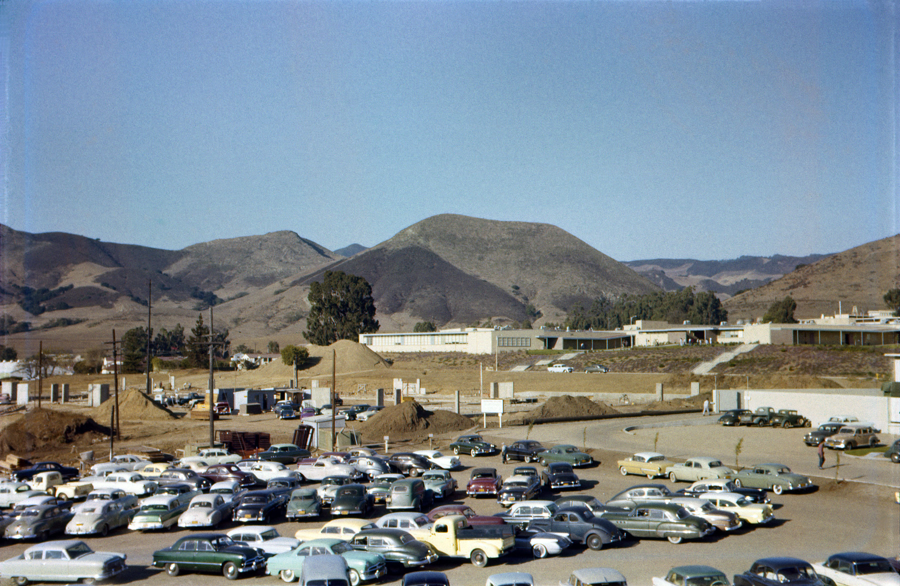 Back in October 1956, my brother shot this Ektachrome slide to show the construction of the new Engineering Building at Cal Poly, and a student parking lot just happened to be in the foreground. Today it looks like a vintage car rally. For extra points: spot the Corvette. View full size.
