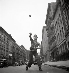 New York, July 1948. "Young boy tossing a ball on a city street." Photograph by Cornell Capa, Life image archive. View full size.