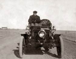 This is a 1903 Winton. Place, time and photographer unknown. 
The First cross country road trip?If that's a Winton, and this pic is from 1903
Then it's likely either Horatio Nelson Jackson or Sewall Crocker and the first car to drive across America, 63 days of mud and breakdowns, but they made it from San Fran to New York City
http://www.history.com/news/the-first-great-american-road-trip
(ShorpyBlog, Member Gallery)