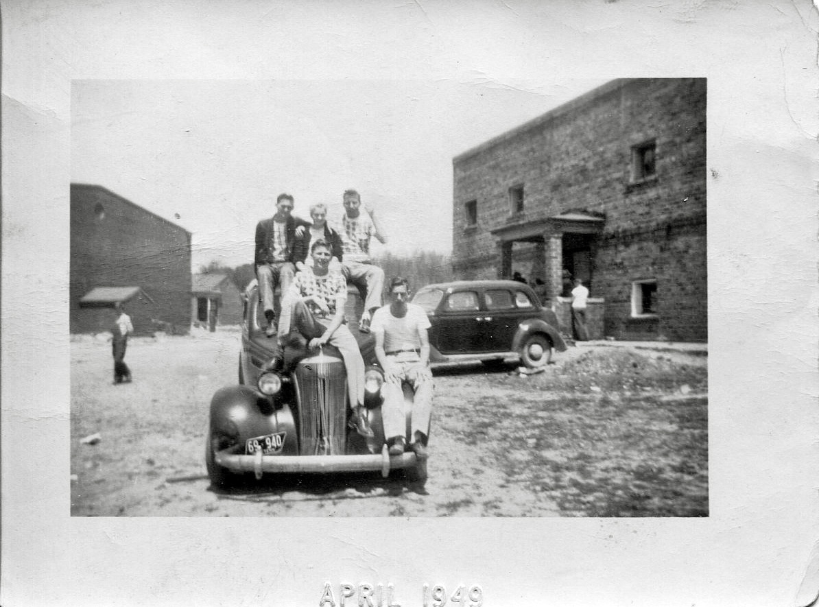 A cute shot of my great uncle and pals on someone's car in front of Coalfield High in Coalfield, Tennessee. View full size.