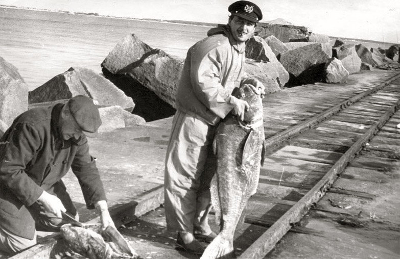 Summer of 1964. Fishing at Molhes da Barra (Cassino Beach, city of Rio Grande, state of Rio Grande do Sul, Brazil).  My grandfather José Bacchieri Duarte (black cap) and a friend. View full size.