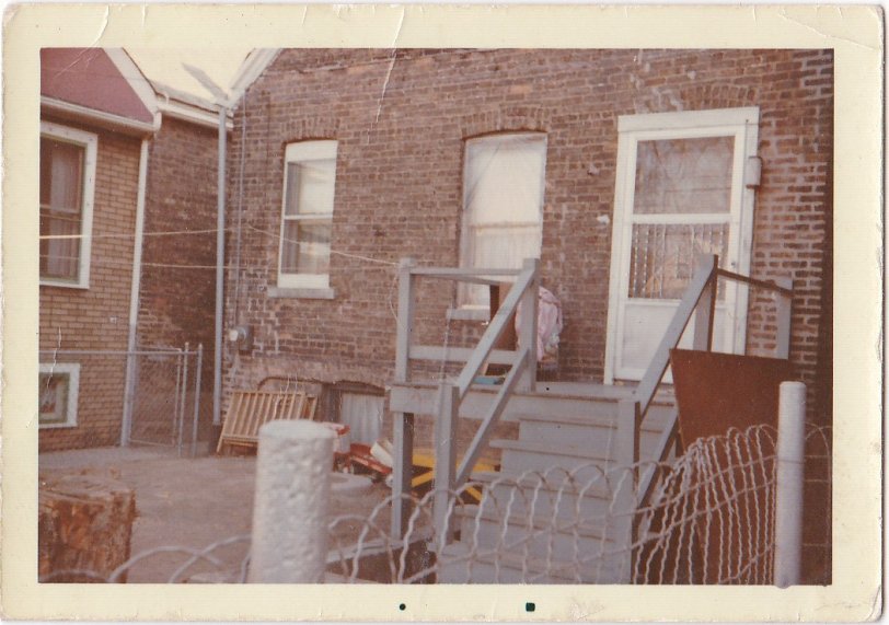 Here is a back view of our first house my Dad bought in Chicago IL around 1962. I believe it was built around 1892 or so.  But could be earlier than that.  If I remember correctly the window to the left on the ground was the old coal chute. View full size.
