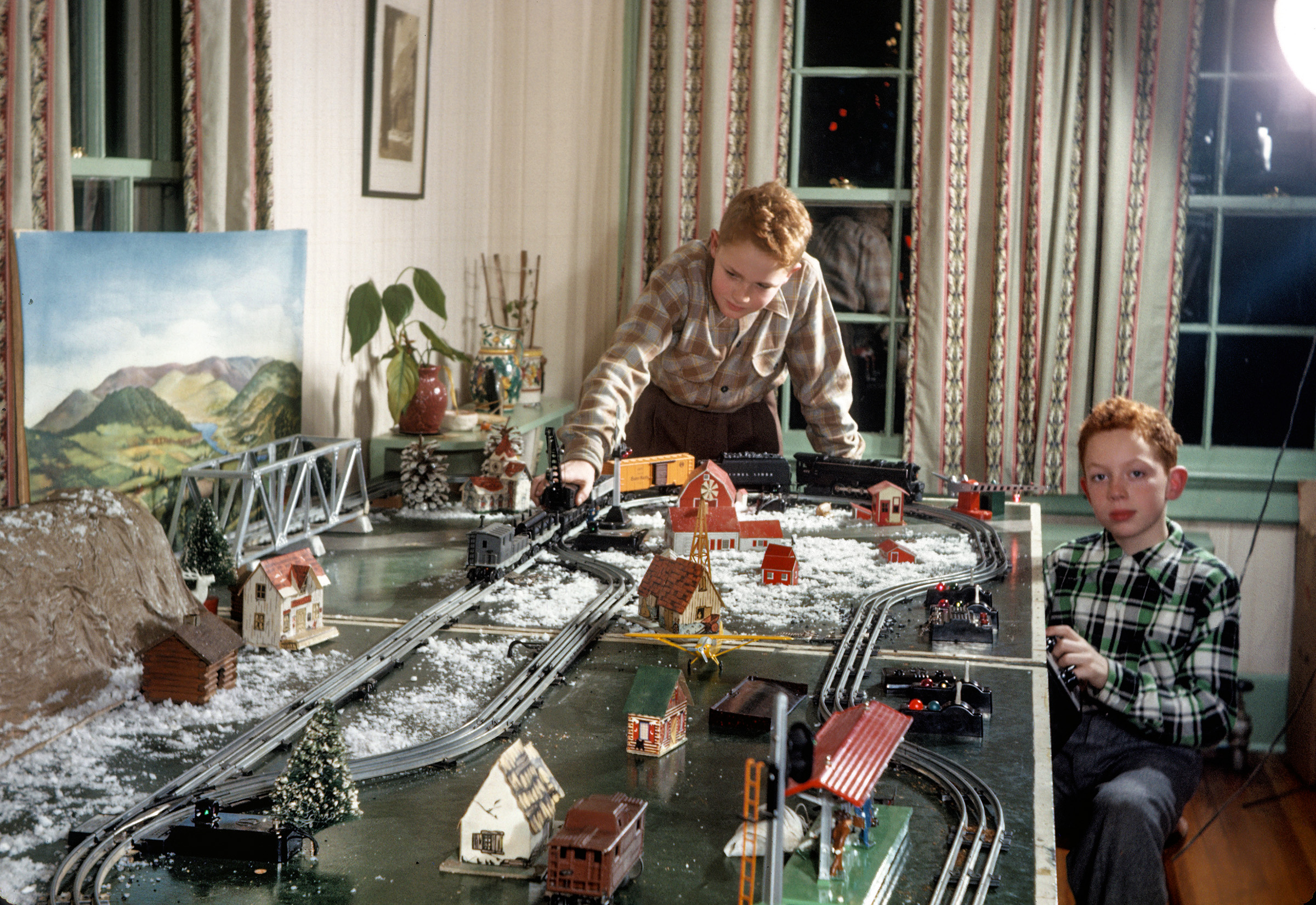 From circa 1946 comes this 35mm Kodachrome of Jim and Jack Hardman and their Christmas train set in Upper Montclair, New Jersey. View full size.
