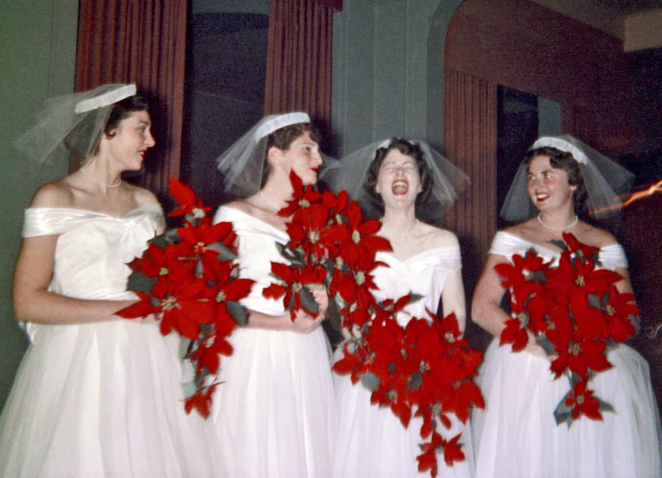 December 12, 1954. A quartet of poinsettia-brandishing bridesmaids share a moment of post-ceremony frivolity at my cousin's wedding reception, held at some ritzy country club on the San Francisco peninsula. I was eight at the time and still have some hazy memory of being in awe of this opulent venue, at the time the fanciest place I'd ever been in. More recently, I was taken aback to read in an article in The San Francisco Chronicle that the use of poinsettias in Christmas decor was now looked down upon by many as, if not merely old school, downright passé. Shows you how much I've been paying attention. My brother shot this 120 620 Kodacolor, taking advantage of the professional photographer's electronic flash by opening the shutter of my sister's Kodak Duaflex moments before the flash fired, thus explaining the candle streak at the right. View full size.