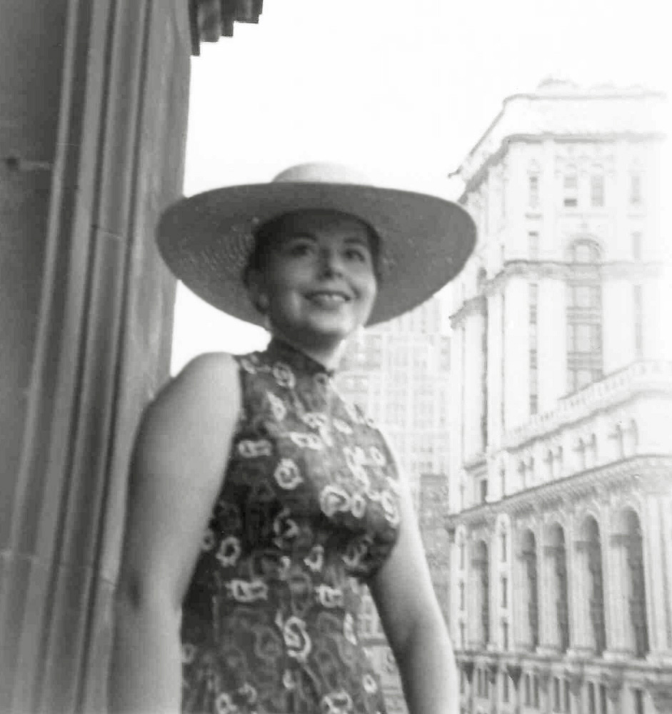 My 20-something mother stands in a window or doorway with a broad brimmed hat, somewhere in her native New York City. Beyond that this shot comes off as mighty city slicker elegant, I know nothing more about it.