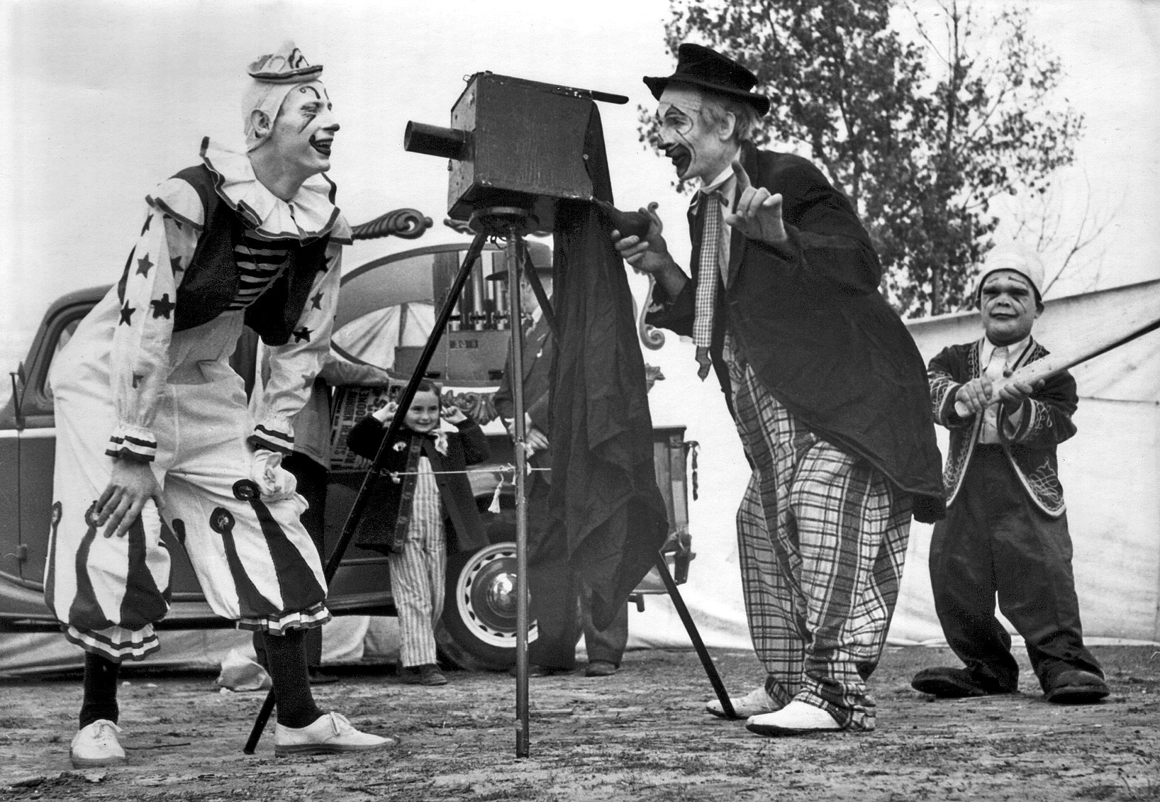 1947 or 48. Webster Brothers Circus clowns. Middle clown is Happy Holmes, my wife is in the back, holding her ears. View full size.