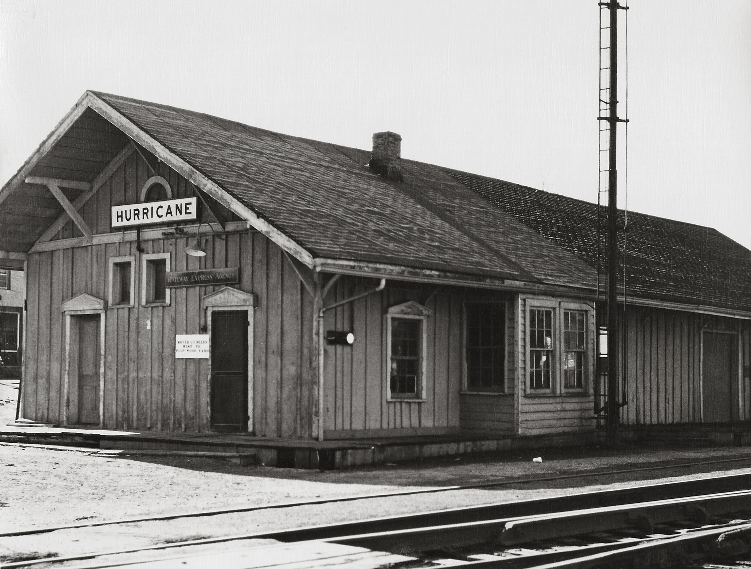 Taken sometime in the 1940's, this is the old C & O Railroad depot in Hurricane, W.Va. Until the 1960's an occasional passenger train stopped here as well as a few freights. If I remember correctly, it was torn down about 1970 and the wood used to build a barn for the Chief of Police. The area then became a parking lot and a rather cheesy gazebo was built later next to the tracks. About 15 or so years ago, the large water tank just down the track was demolished. The switch tower across the tracks was also razed quite a few years ago. I was only about 11 years old when the depot was torn down and even then I was mad as a hornet about it. What makes this so ironic is the fact that Hurricane owes its existence to the railroad, having been moved nearly 2 miles from the James River and Kanawha Turnpike so as to be near the new track in 1873. The only commemoration of our ties to the C & O now are a very small museum in a caboose behind the fire station and a couple of murals on the fire station walls. This image was given to my Aunt by the high school librarian who was an avid photographer. He was still teaching when I was in high school and he led the photography club.  I still have it in its frame. View full size.