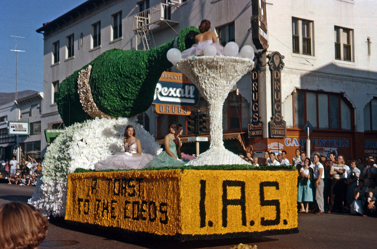 1956 Cal Poly Homecoming Parade, San Luis Obispo. They're toasting the coeds because this is the first year Cal Poly had them. I don't know what I.A.S. stands for, but student clubs and societies associated with their majors generally sponsored floats. My brother's 35mm Ektachrome slide. View full size.