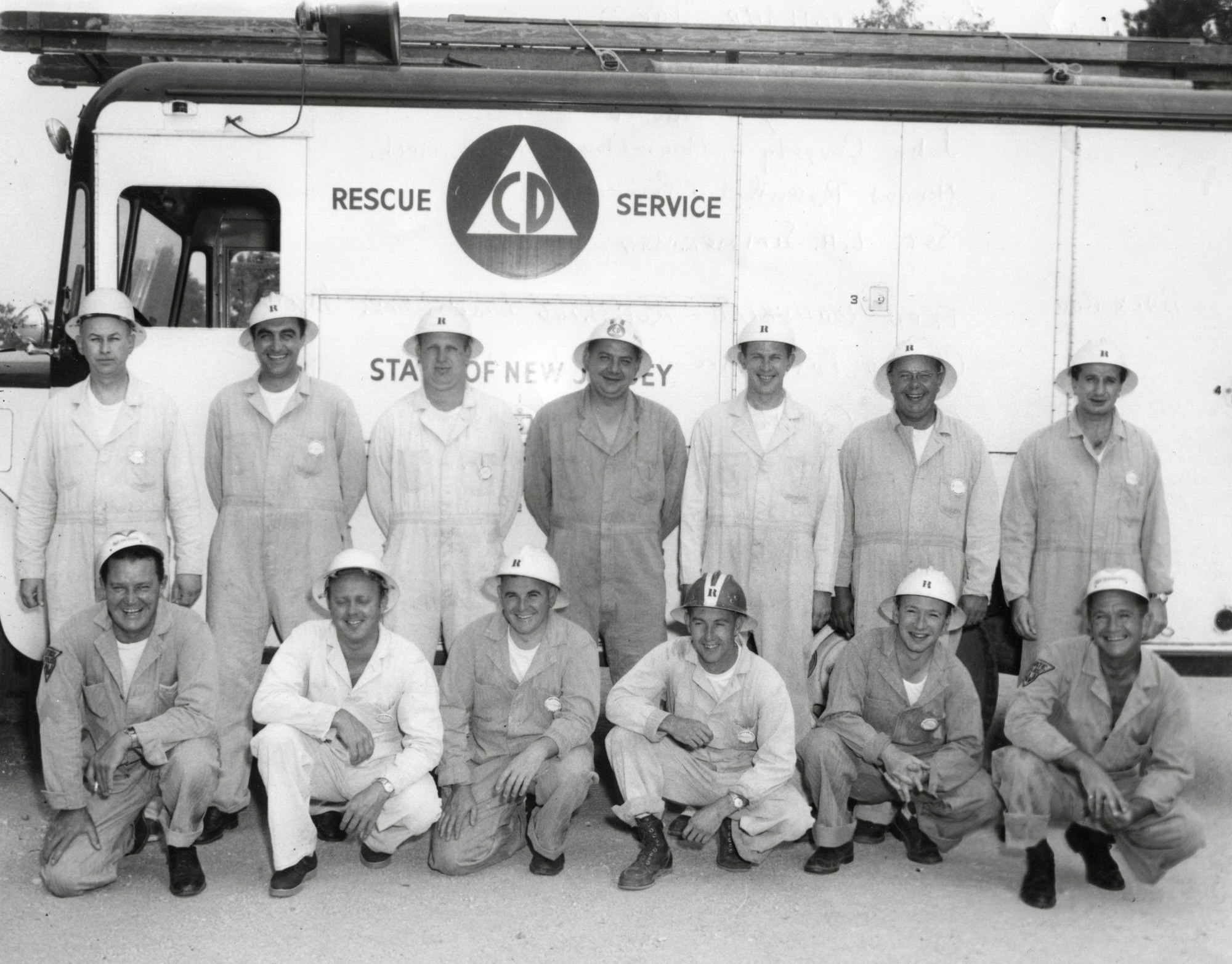 As part of some kind of civil service, RCA sent my father and other employees to Hammonton, New Jersey in June, 1959 to take a course in Heavy Rescue that was put on by the State of New Jersey Division of Civil Defense and Disaster Control. The back of this photo lists the names of each of these men and their jobs. One is Assistant Chief Ray Dobbs of the Collingswood Fire Company, two are foremen from RCA’s Camden, NJ plant. Tony DiMaggio (standing, far right) was with the Camden police. My father is on the bottom row, next to the last position, if you count the far left as the first. His normal attire was a suit and tie, definitely not coveralls and a hard hat. I can only assume the attire was borrowed for this training exercise because he never owned any clothes like that. View full size.