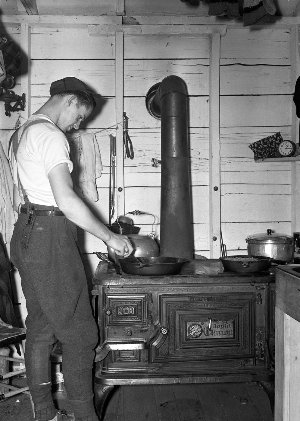 From a series in my negatives collection titled "Hunting Cabin." Can't read the brand of the stove too well, but it dates from 1887. Wonder what he's making? View full size.