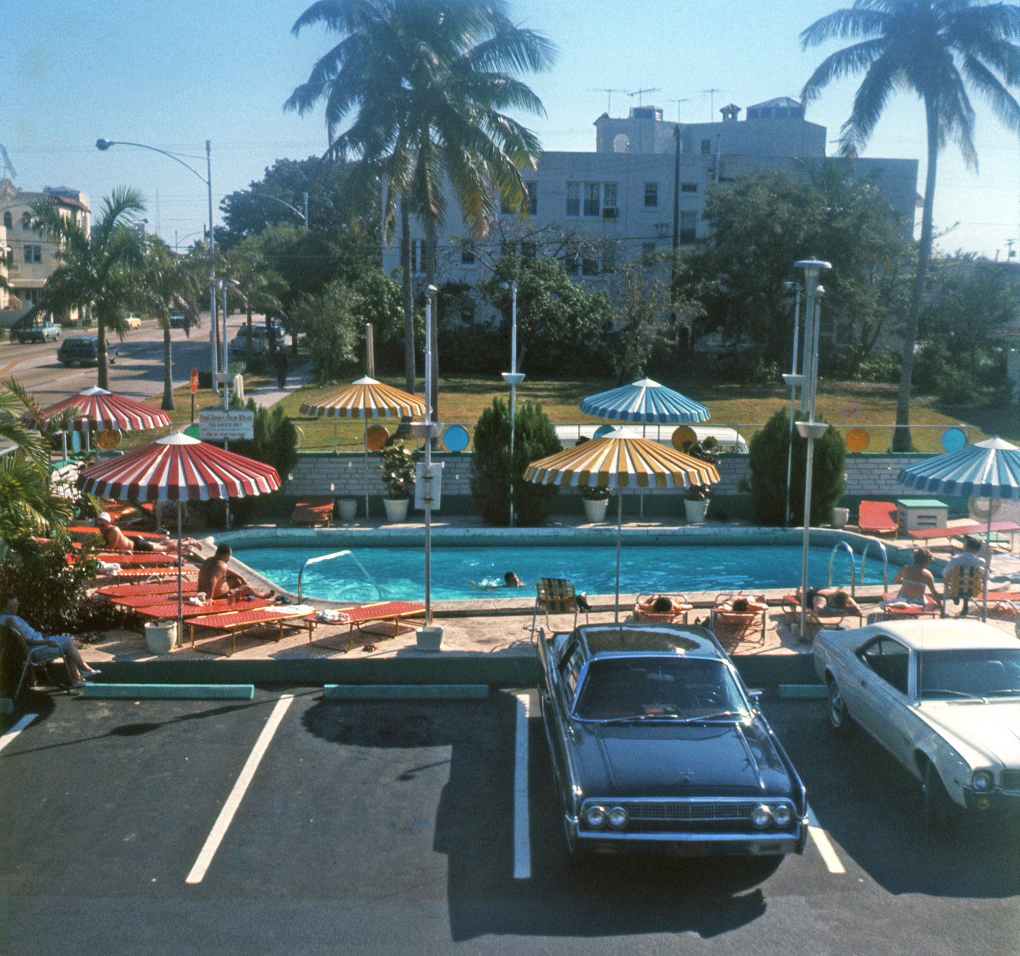 From a bunch of old family slides a friend is having me scan. Location isn't specified, but is possibly Florida, like many of the others. I do know the black car is a 1963 Lincoln Continental and the white one an AMC Javelin c.1969. 126 Ektachrome. View full size.