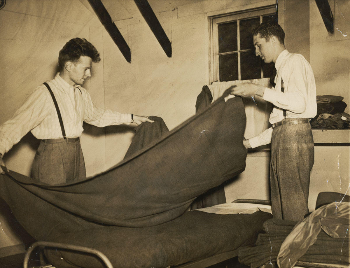 "Associated Press photo from New York -- Charles Miller* (left), Newark, N.J., and Robert Dodds, Montclair, N.J., make up a bed in their quarters after reporting for a year's duty in the first U.S. camp for conscientious objectors, opened May 15 (1941), at Patapsco State Park, near Elk Ridge, MD."

*Following his service at Patapsco, Dad was reassigned to the NRDC Research on Sound Control project at Harvard. -- Steve Miller