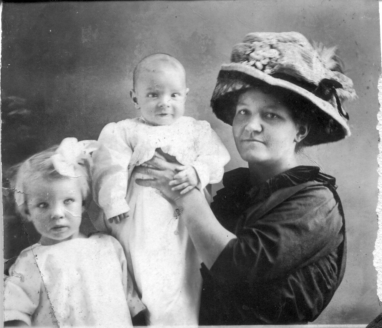 Another from my paternal grandmother's collection. Unknown which family members they are but both kids appear to be cross-eyed. Baby doesn't seem to mind though and mom is still proud. View full size.